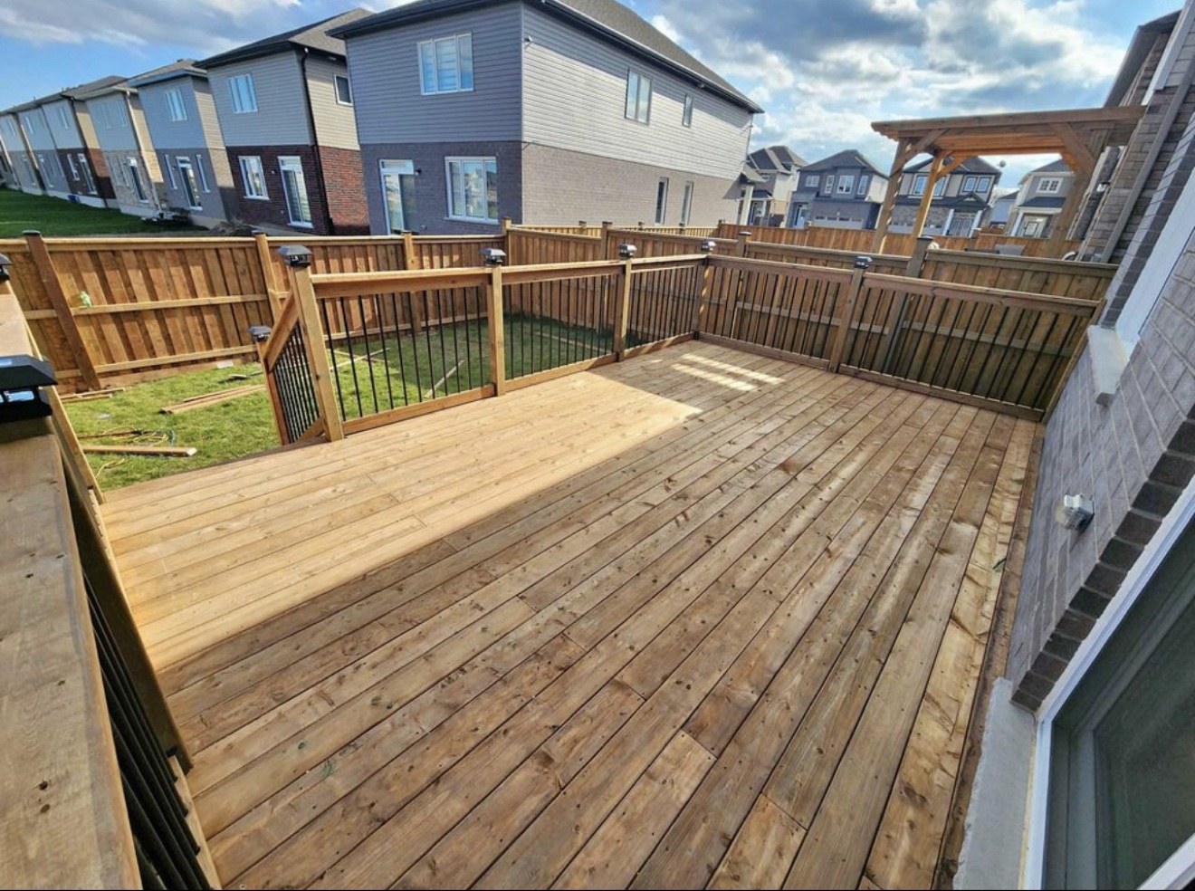 Wood deck finished with black metal railings