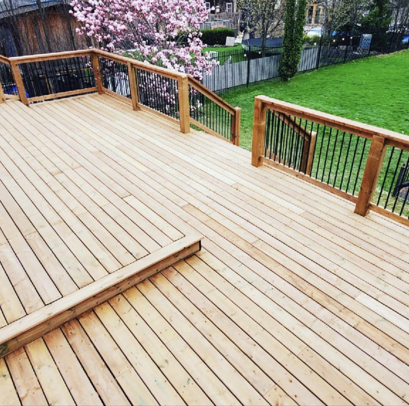 Large two-tier residential deck with railings