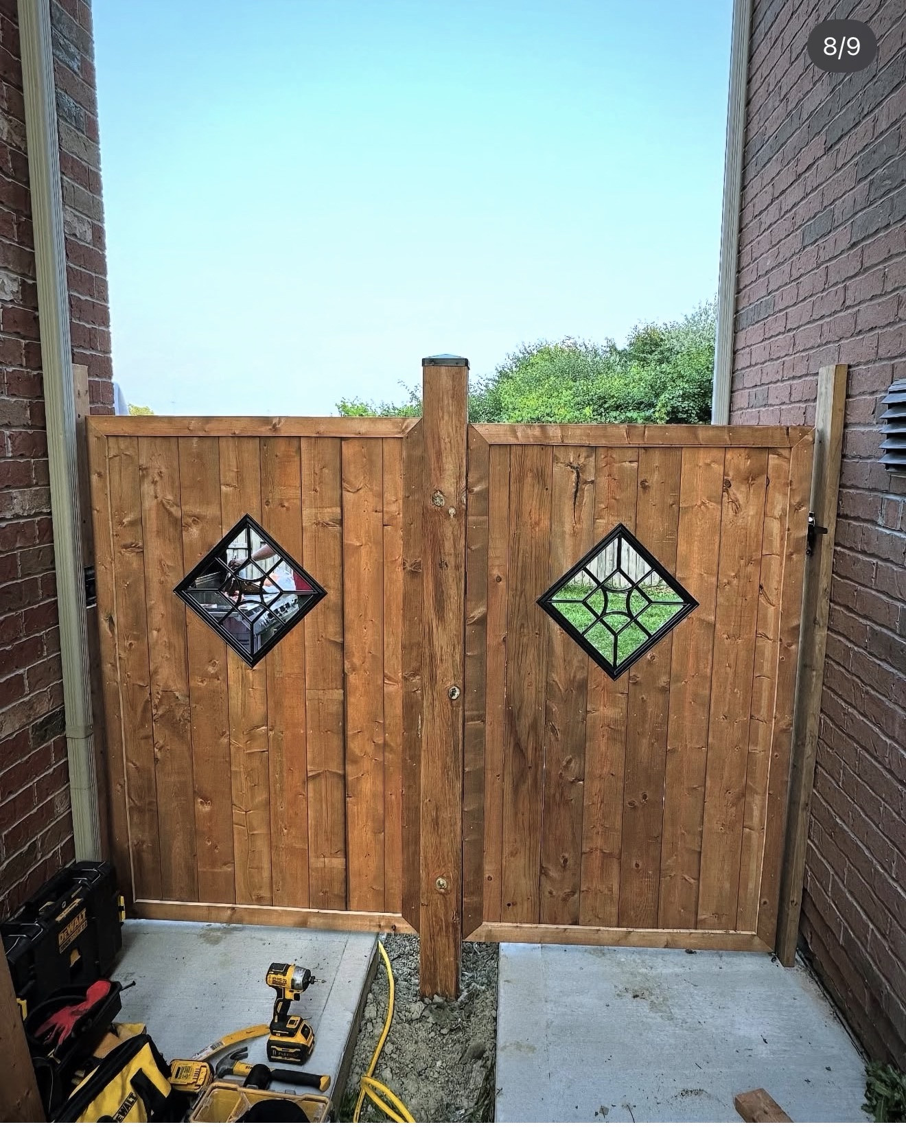 Custom double wood gate with two decorative diamond windows